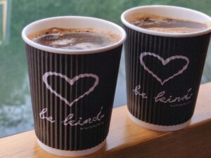Picture of 2 cups of coffee with a heart on them and the message 'be kind'.